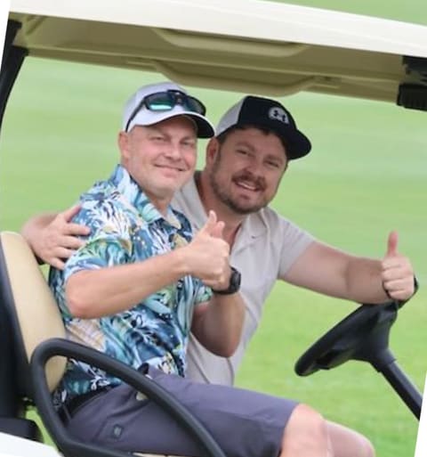A golfer celebrating with arms raised