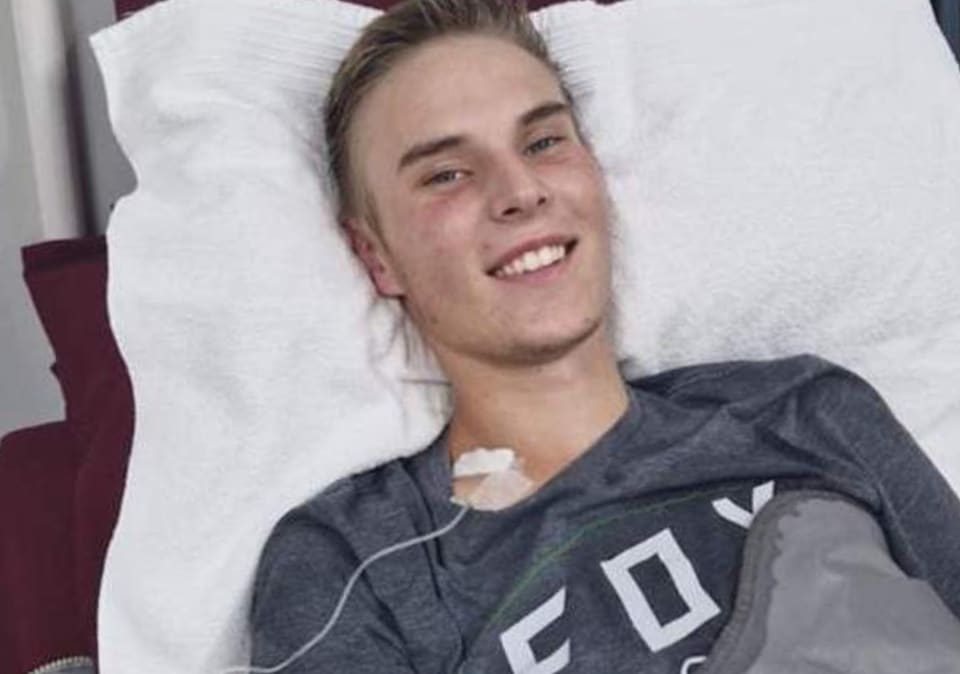 Nico smiling from his hospital bed